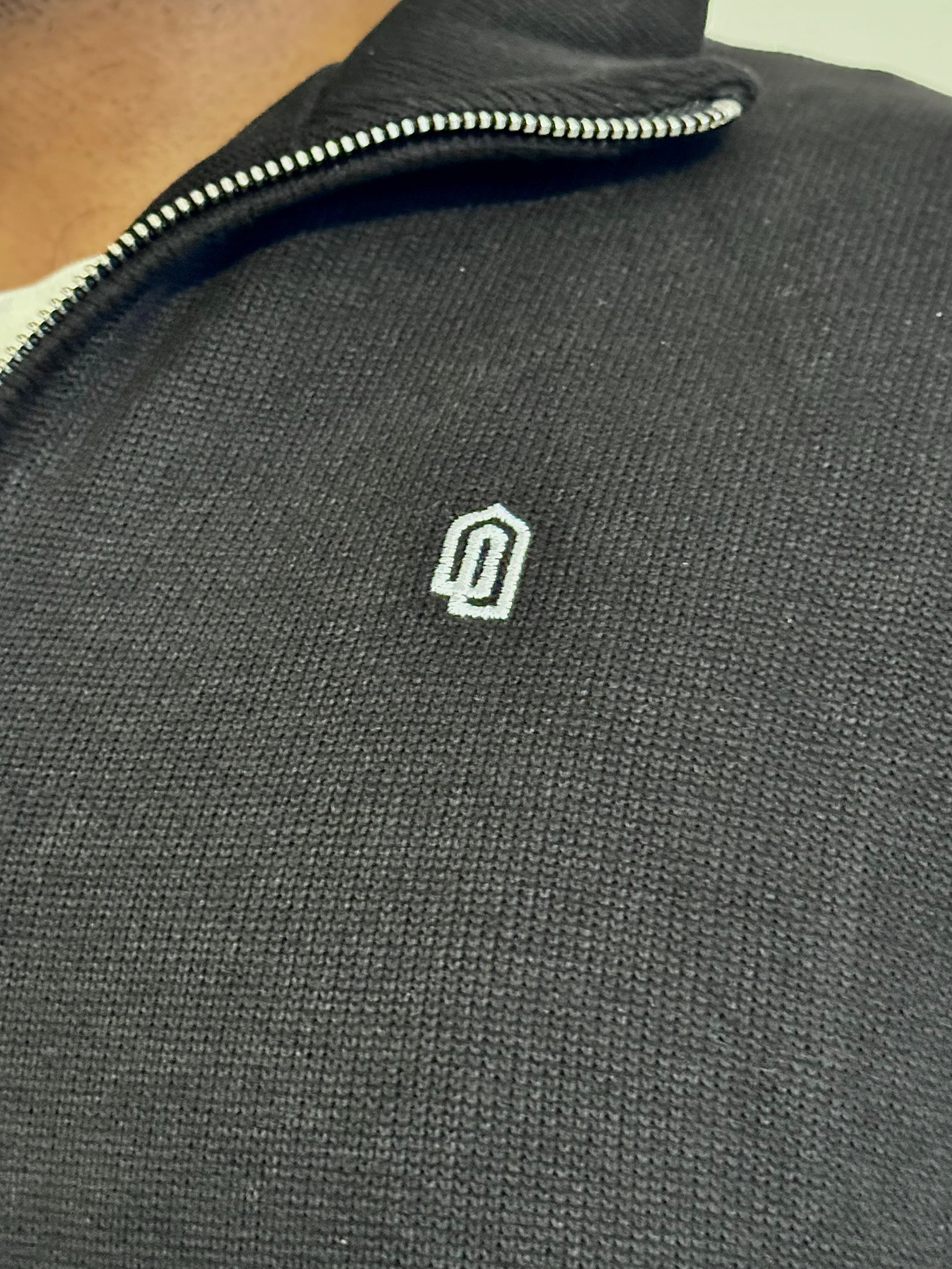 Black Limited Edition Quarter Zip Thobe, embroidered logo close-up