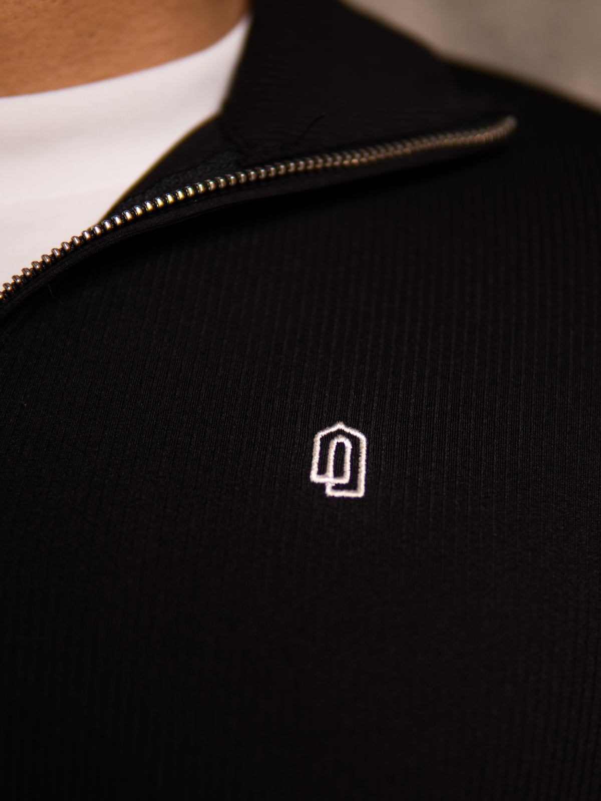 Black Refined Quarter Zip Thobe, embroidered logo close-up