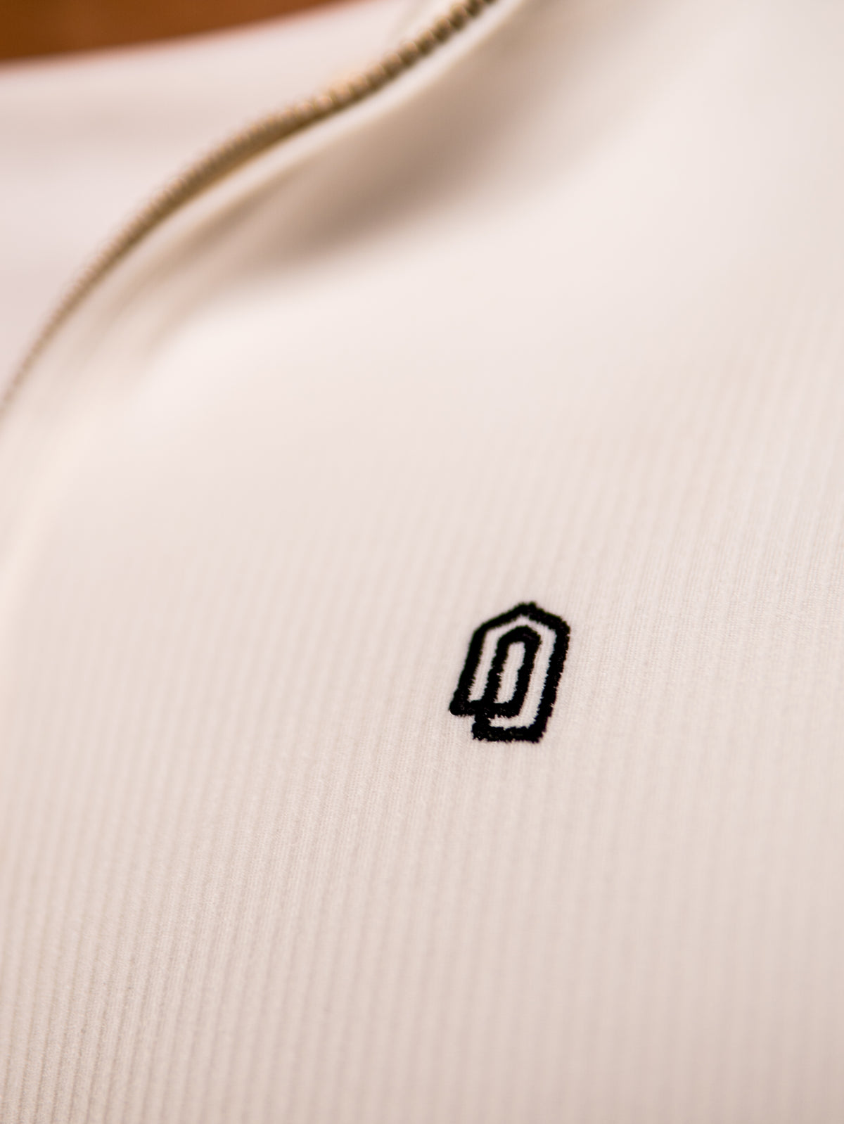 White Refined Quarter Zip Thobe, embroidered logo close-up